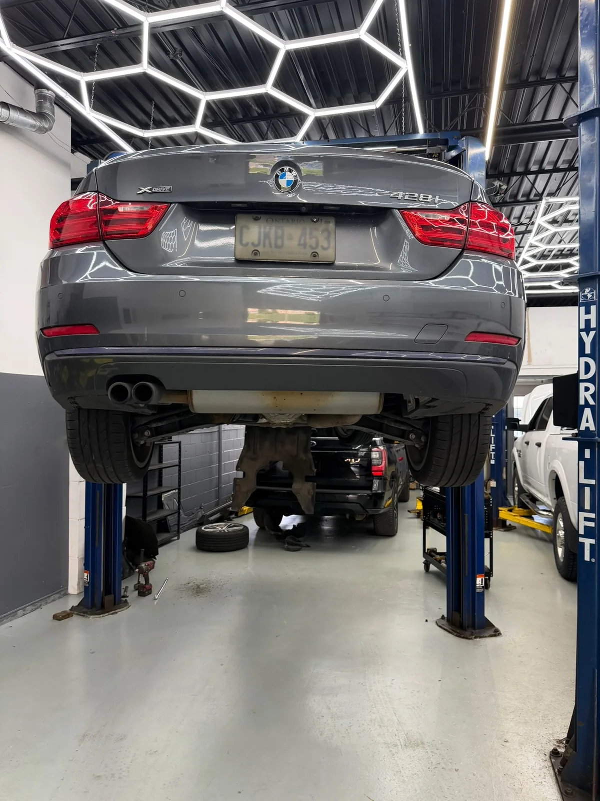 BMW on a lift inside the Ajax Motorlux shop